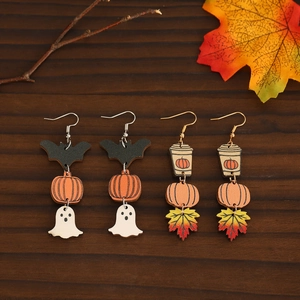 Halloween wooden earrings featuring pumpkin ghost and maple leaf on rustic wood background