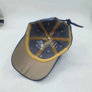 Detailed interior of vintage blue denim baseball cap showing sweatband and metal buckle