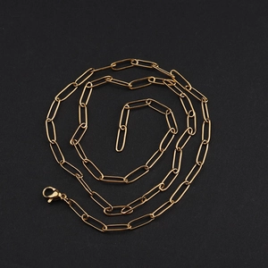 Detail shot of golden paperclip chain with oval links and a secure lobster clasp