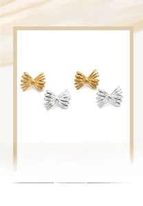 Detail view of gold and silver bow stud earrings with delicate radial textured etching