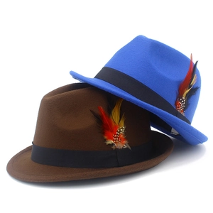 Detail view of colorful feathers on classic blue and brown wool felt fedora hats