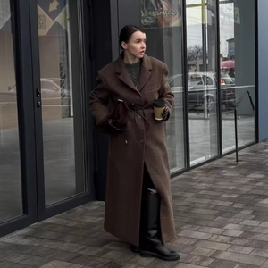 Chic dark brown oversized wool coat with long silhouette for stylish women in street style