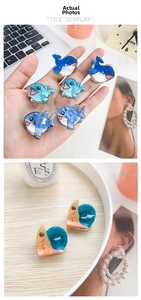 Detailed close-up of cute acrylic animal hair clips featuring whales and dolphins