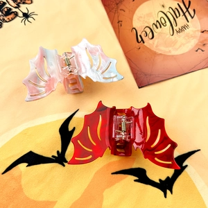 Detail of pink marble and translucent red bat hair claws for festive Halloween styling