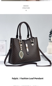 Detail of coffee leather tote with gold hardware and pearl leaf charm accessory