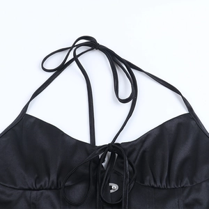 Detail of black satin halter top with adjustable tie-up chest and subtle pleats