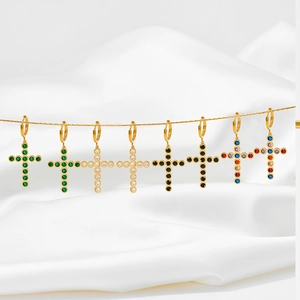 Gold stainless steel cross earrings with colorful zircon stones on white silk background
