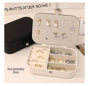 Close-up of portable jewelry box with multi-compartment storage for rings and earrings