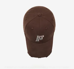 Macro detail of vintage brown baseball cap featuring 3D letter F embroidery and distressed brim