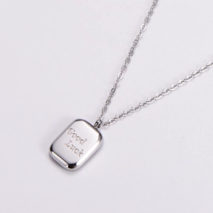 Minimalist silver square pendant necklace featuring engraved Good Luck script details