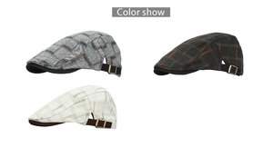 Detail of checkered flat caps in grey, brown, and cream with bronze metal buckles