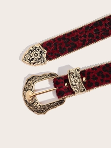 Detail of red leopard print belt with vintage gold engraved buckle and metallic trim