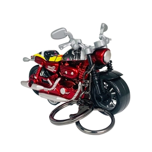 Red metal motorcycle keychain with speed logo and dual silver exhaust pipes