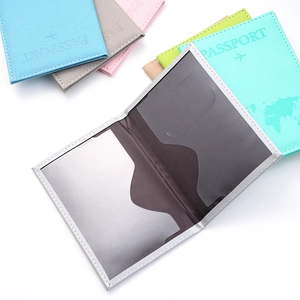 Close-up of colorful PU leather passport covers with map texture and internal card slots