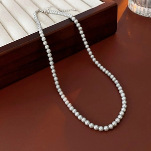 Detailed view of elegant single-layer pearl necklace with adjustable silver lobster clasp