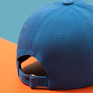 Close-up of distressed baseball cap back with silver metal buckle and twill fabric texture