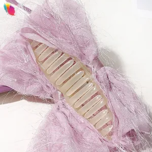 Detail of the pink-purple chiffon bow hair claw showing the textured brushed fabric