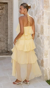 Detail of light yellow tiered ruffle chiffon maxi dress with halter neck design