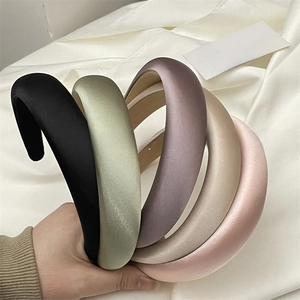 Close-up of padded satin headbands in a variety of elegant Morandi colors