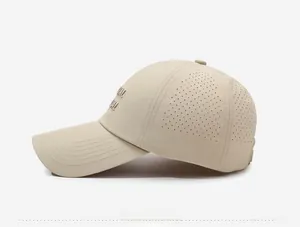 Detail of laser-perforated breathable holes and 3D embroidery on beige baseball cap