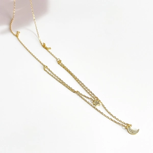Elegant gold double-layer necklace featuring sparkling star and crescent moon pendants