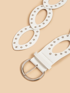 Detailed view of a white faux leather belt featuring oval cutouts and silver metal studs