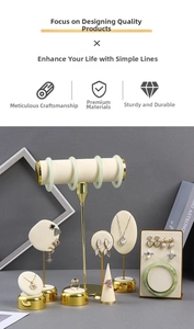 Detailed jewelry display set with gold metal frames and beige velvet padding surfaces