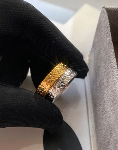 Macro shot of gold and silver plated rings with deep embossed floral textures