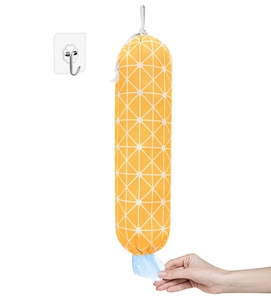 Detailed view of yellow wall-mounted bag dispenser with hand pulling a plastic bag