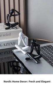 Detailed close-up of Nordic abstract thinker statues in matte black and white finishes
