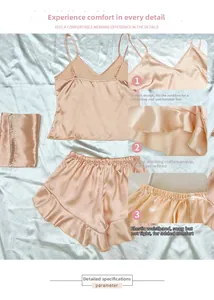 Detail of V-neckline and ruffled hem on peach pink silk camisole pajamas set