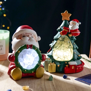 Christmas tree and Santa Claus night lights with glowing natural crystal cave stones