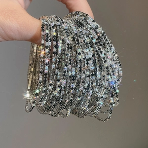 Detailed close-up of multi-layer sparkling silver bracelet with black and white rhinestones