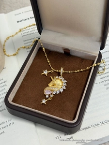 Detail of 18k gold plated unicorn necklace with marquise zircon and pink gemstone inlay