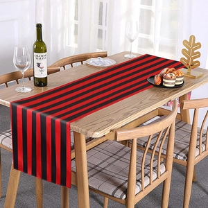 Modern minimalist red and black striped table runner on a wooden dining table