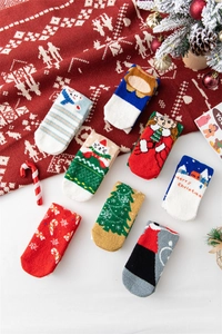 Detail of soft coral fleece Christmas socks featuring festive patterns and plush texture
