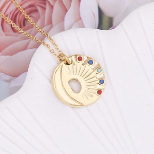 Golden sun and crescent moon geometric pendant necklace with colorful gemstones