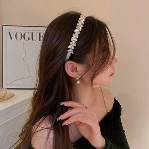 Detail of silver headband with sparkling marquise and round crystals on a model