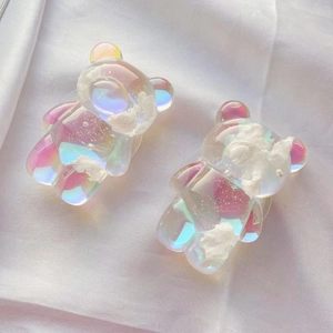 Detail of colorful transparent bear phone holders with cloud fillings and glitter effect