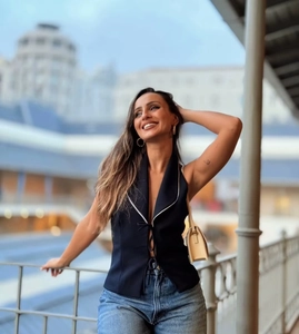 Détail du crop top dos nu noir avec passepoil blanc et laçage frontal décoratif