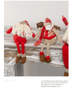 Detailed view of sitting Santa and Reindeer plush dolls on a festive white mantelpiece