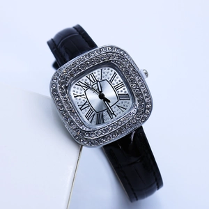 Close-up of luxury silver square watch with diamond bezel and classic Roman numerals