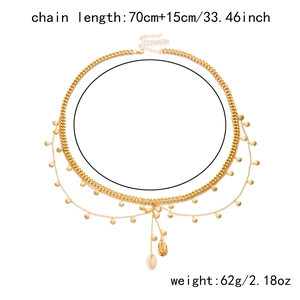 Detail of bohemian gold waist chain featuring shell charms and size specifications