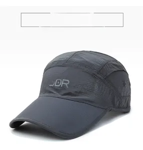 Detailed view of dark grey quick-dry fabric and SDR logo on the 5-panel outdoor cap