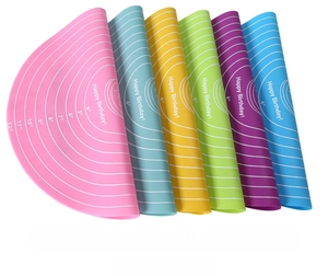 Macro view of colorful 30cm silicone baking mats with measurement scales and festive text