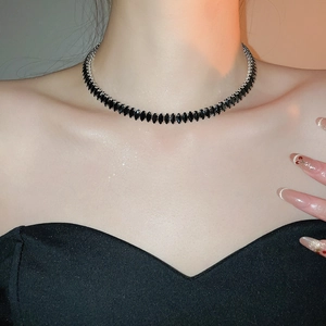 Close-up of a silver choker with marquise-cut black zircons worn by a model