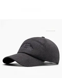 Close-up of THE KINSHOW letter embroidery on dark gray winter warm baseball cap