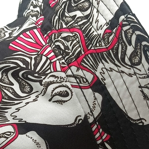 Detailed close-up of cartoon horse print on high-quality fabric of a reversible sun hat
