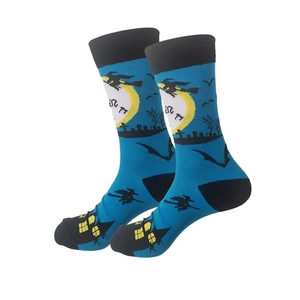 Detail view of teal Halloween socks featuring witch silhouettes and bats on white background