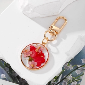 Handmade resin keychain with real dried flowers, gold foil, and gold D-ring fastener